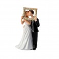 Figurine bride and groom hanging a frame